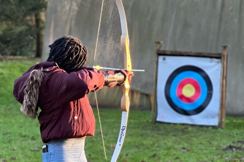 A young person enjoys archery as part of the EmpowHER programme.