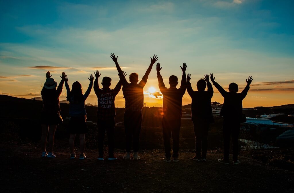 A group of young people in silhouette raise their arms. Picture: Pixabay